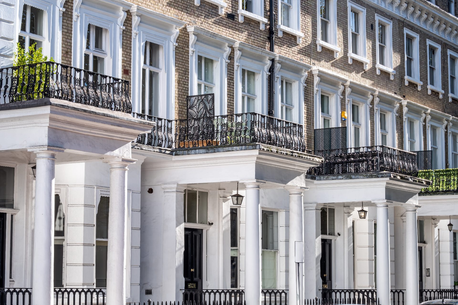 Period London block of flats with white stucco facades and ornate balconies