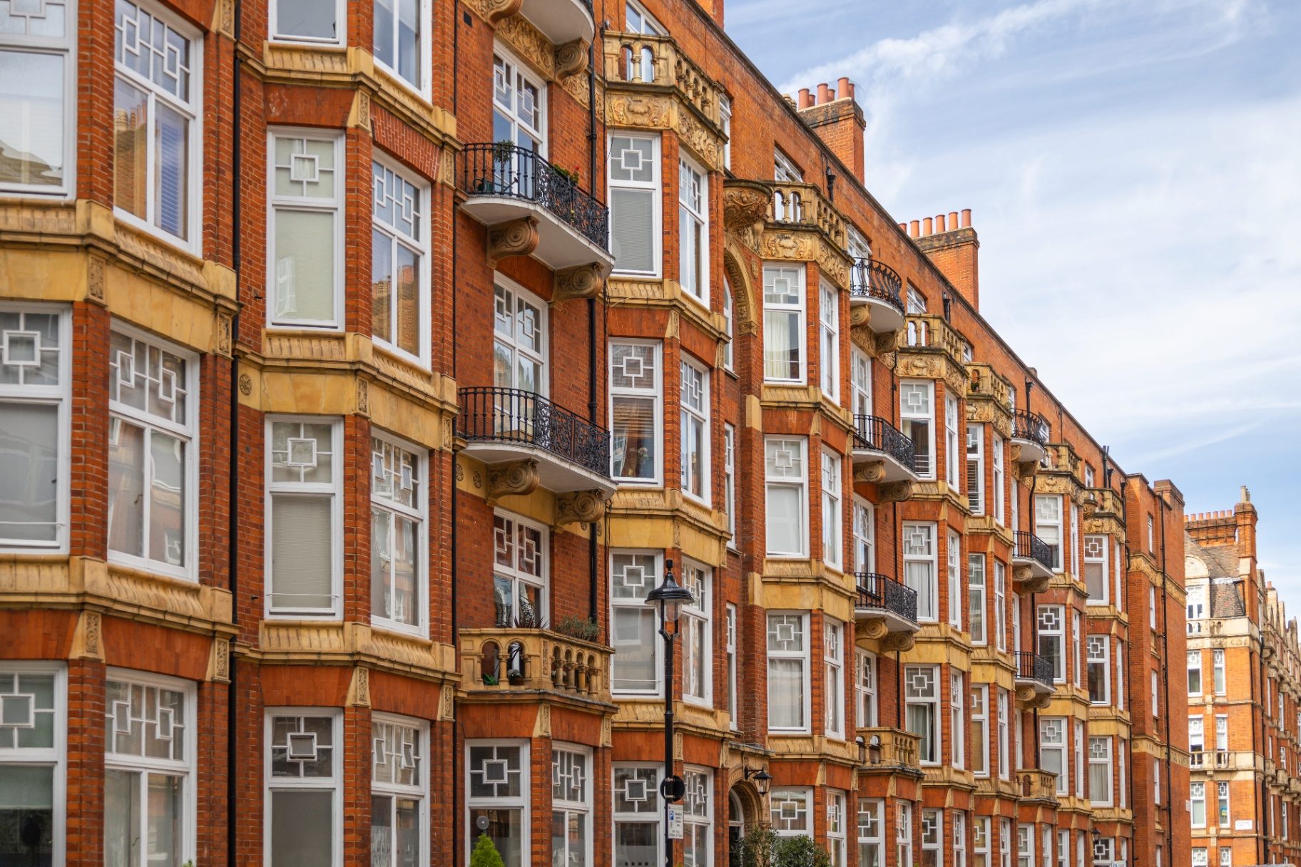 Period red brick block of flats in central London representing block of flats insurance