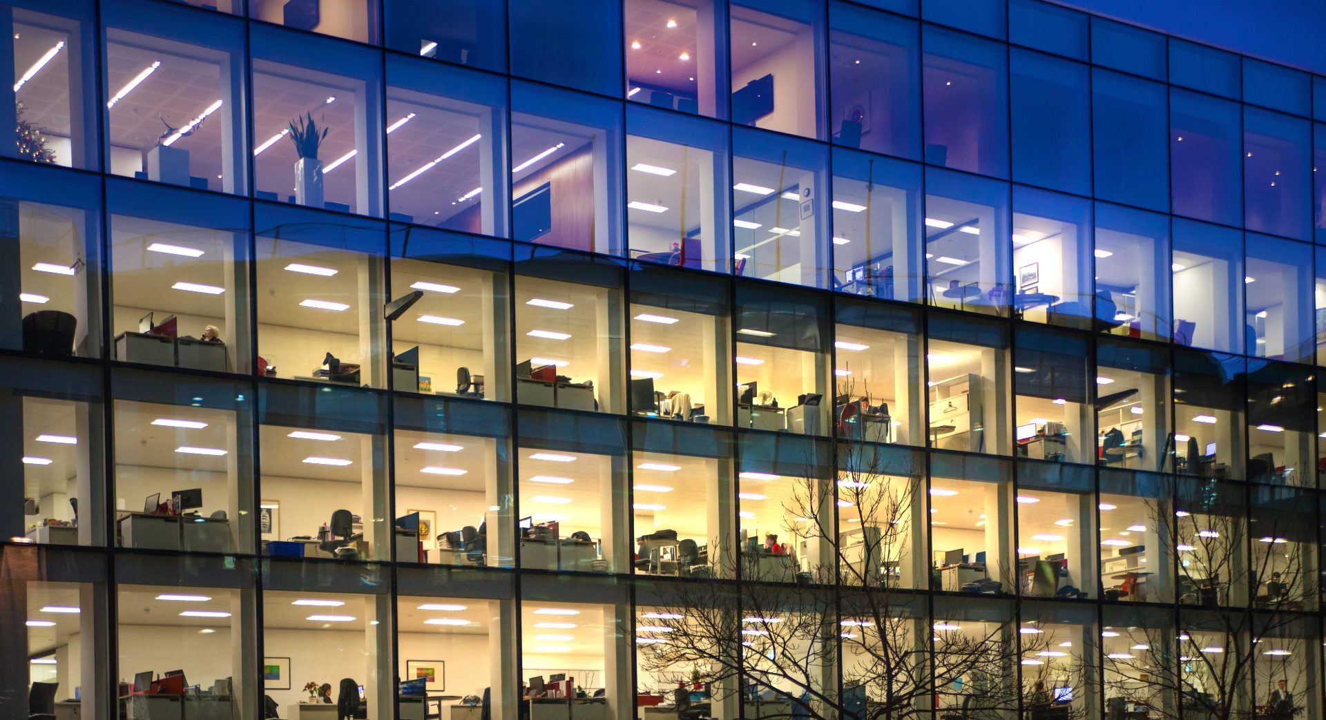 Modern office building at night with illuminated windows