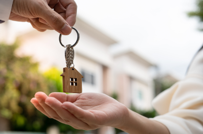 Types of tenants and landlord insurance - hands passing house keys